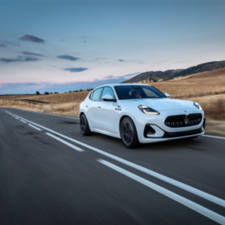 Maserati Grecale Folgore driving down a country road