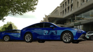A wide shot of a Toyota Mirai hydrogen-powered fuel cell electric vehicle with Bridgestone Turanza T005 tires for Paris 2024.