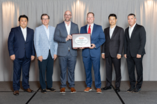 Image of Toyota Executives with Bridgestone award plaque 