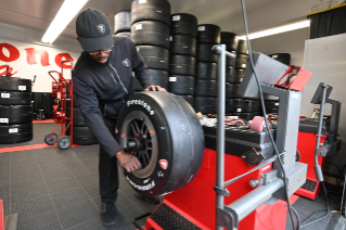 The Firestone Racing team mounting and balancing race tires for the Indy 500.