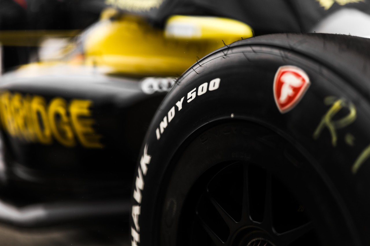 : A close look at the Indy 500 branding on the side of the Firestone Firehawk race tires.